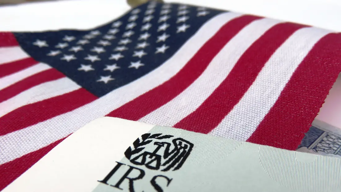 IRS tax forms and an American flag